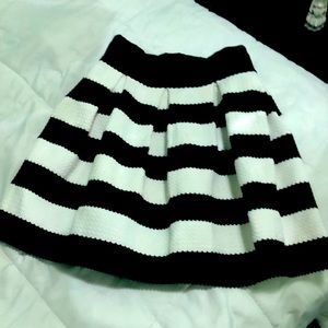 100%Polyester. High waisted upside down cupcake style with pleats!